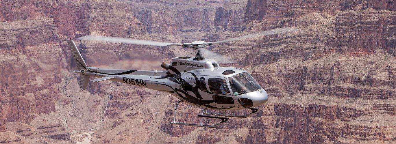 5 Star Helicopters Airbus AS350 flying between the walls of the Grand Canyon West Rim
